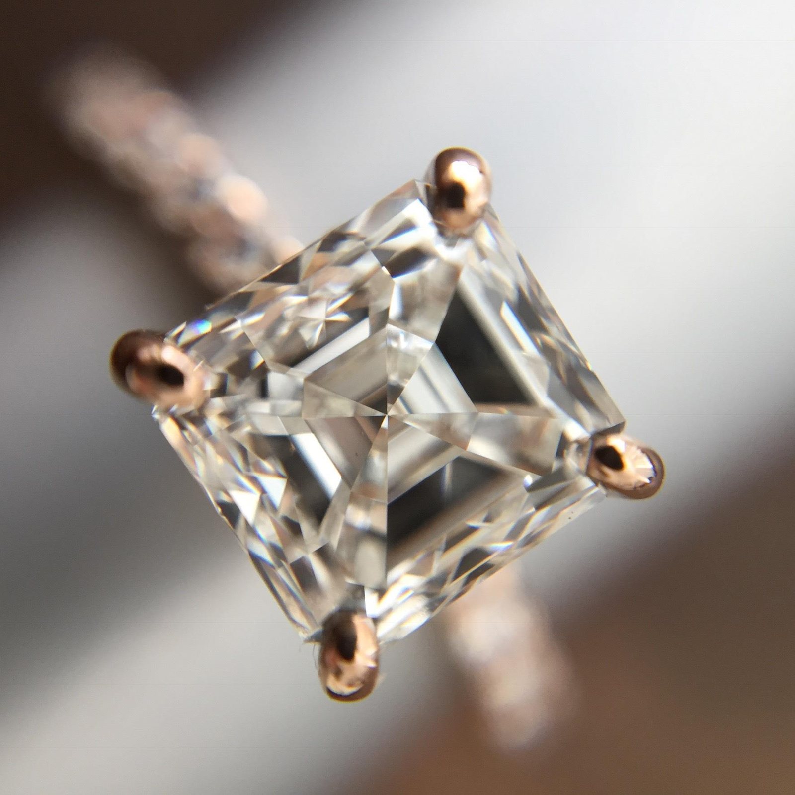 A close-up of the stone set in the ring, held by four prongs.